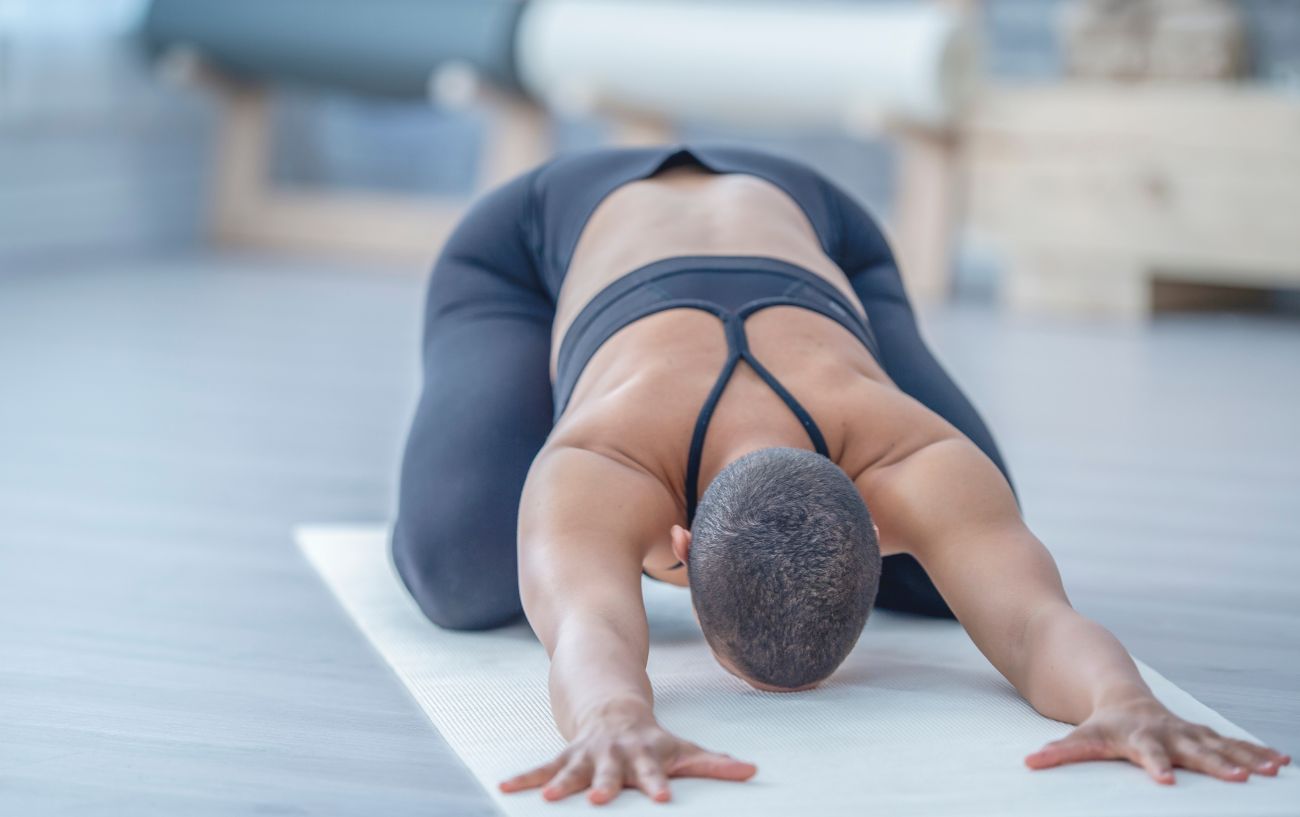 a woman doing childs pose