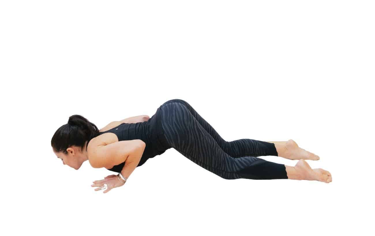 picture of a woman doing a knees chest chin yoga pose